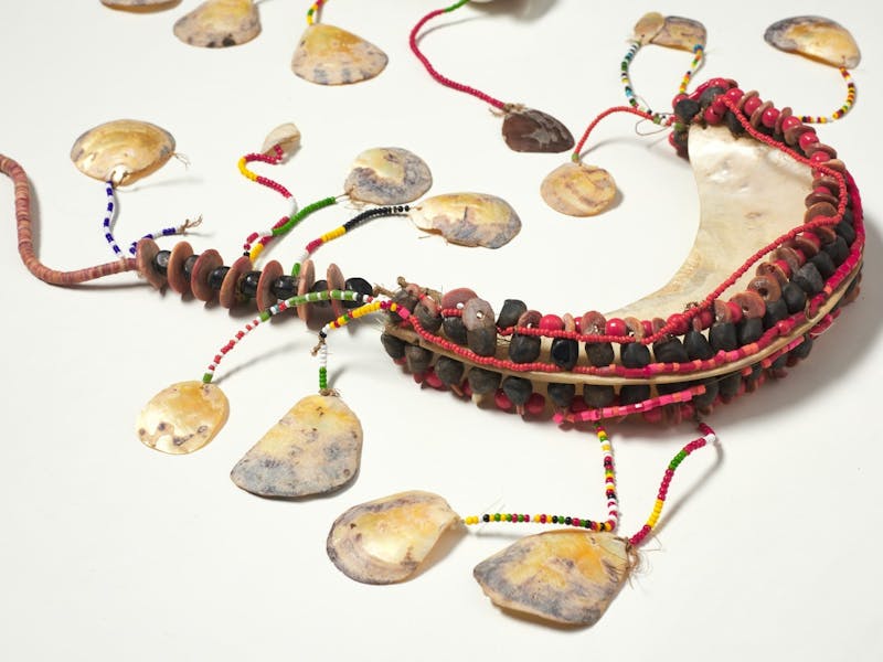 A chest ornament woven with shells and beads.