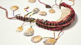 A chest ornament woven with shells and beads.