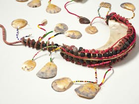 A chest ornament woven with shells and beads.