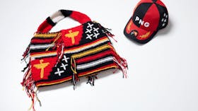 Coloured wool bilum bag and cap in Papua New Guinea national colours.