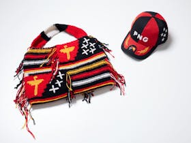 Coloured wool bilum bag and cap in Papua New Guinea national colours.