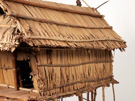 Large house model on stilts depicting a typical village style home.