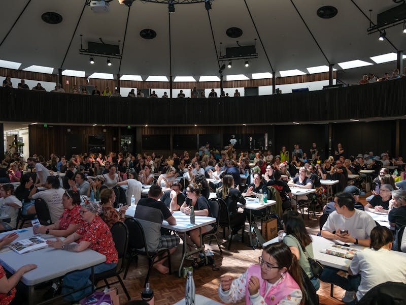 A large room with lots of people sitting at tables
