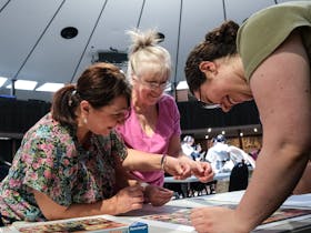 Three women puzzling together