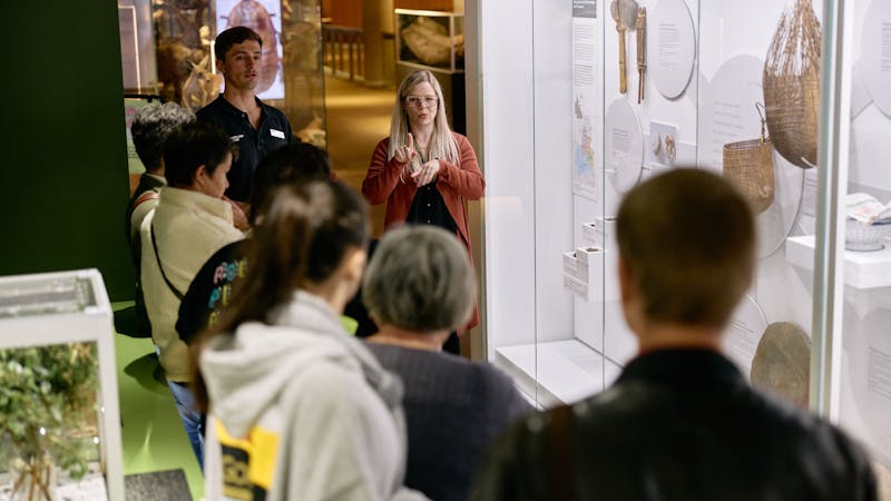 An Auslan interpreter and museum guide lead a tour