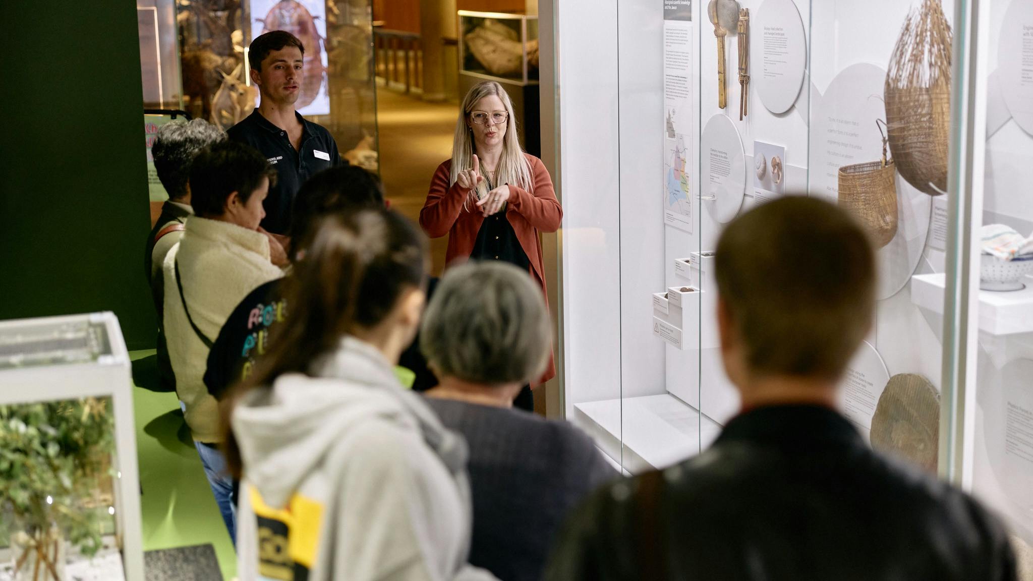 An Auslan interpreter and museum guide lead a tour