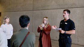An Auslan interpreter and museum guide lead a tour group