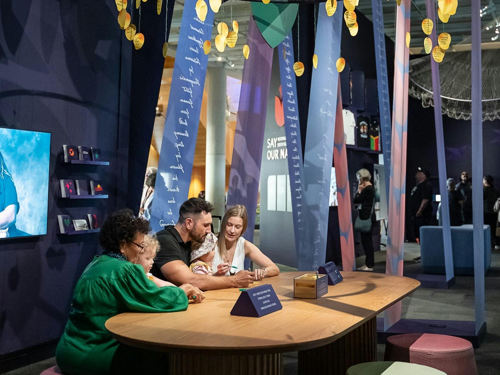 Guests sitting at a table inside exhibition space