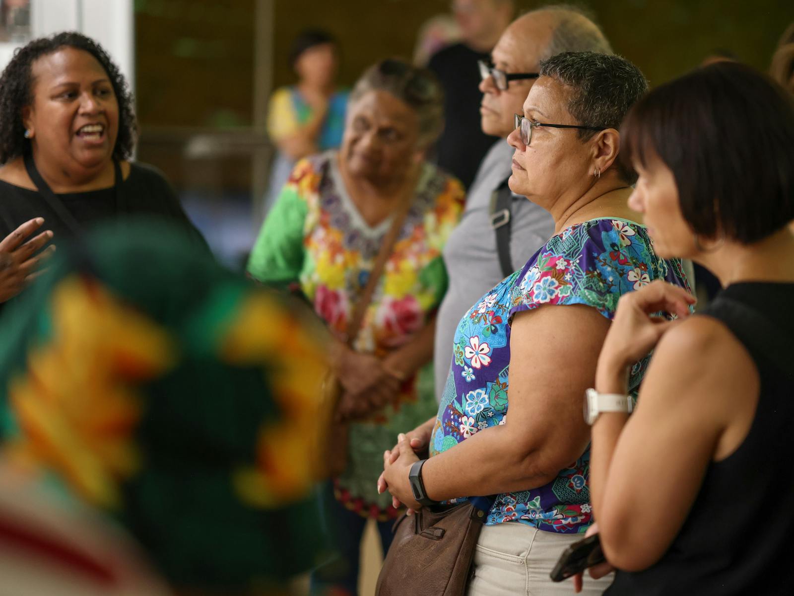 A group on an exhibition tour led by a curator
