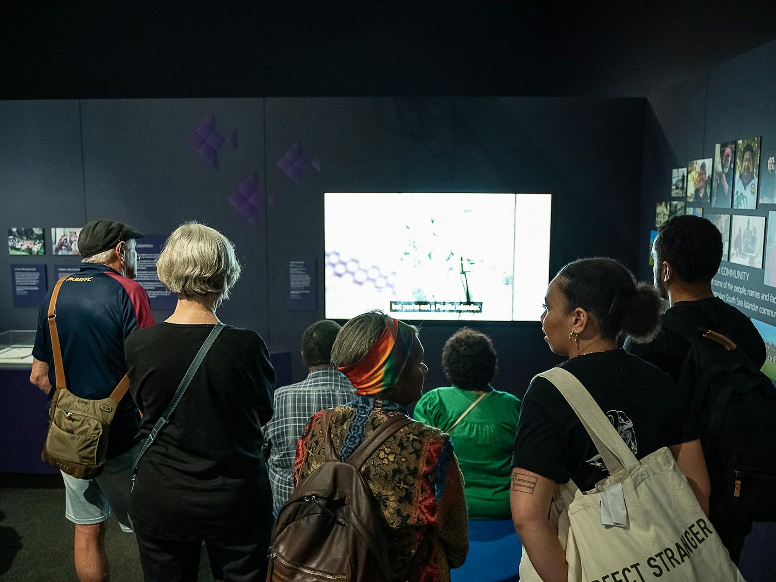 Exhibition visitors in front of a digital story
