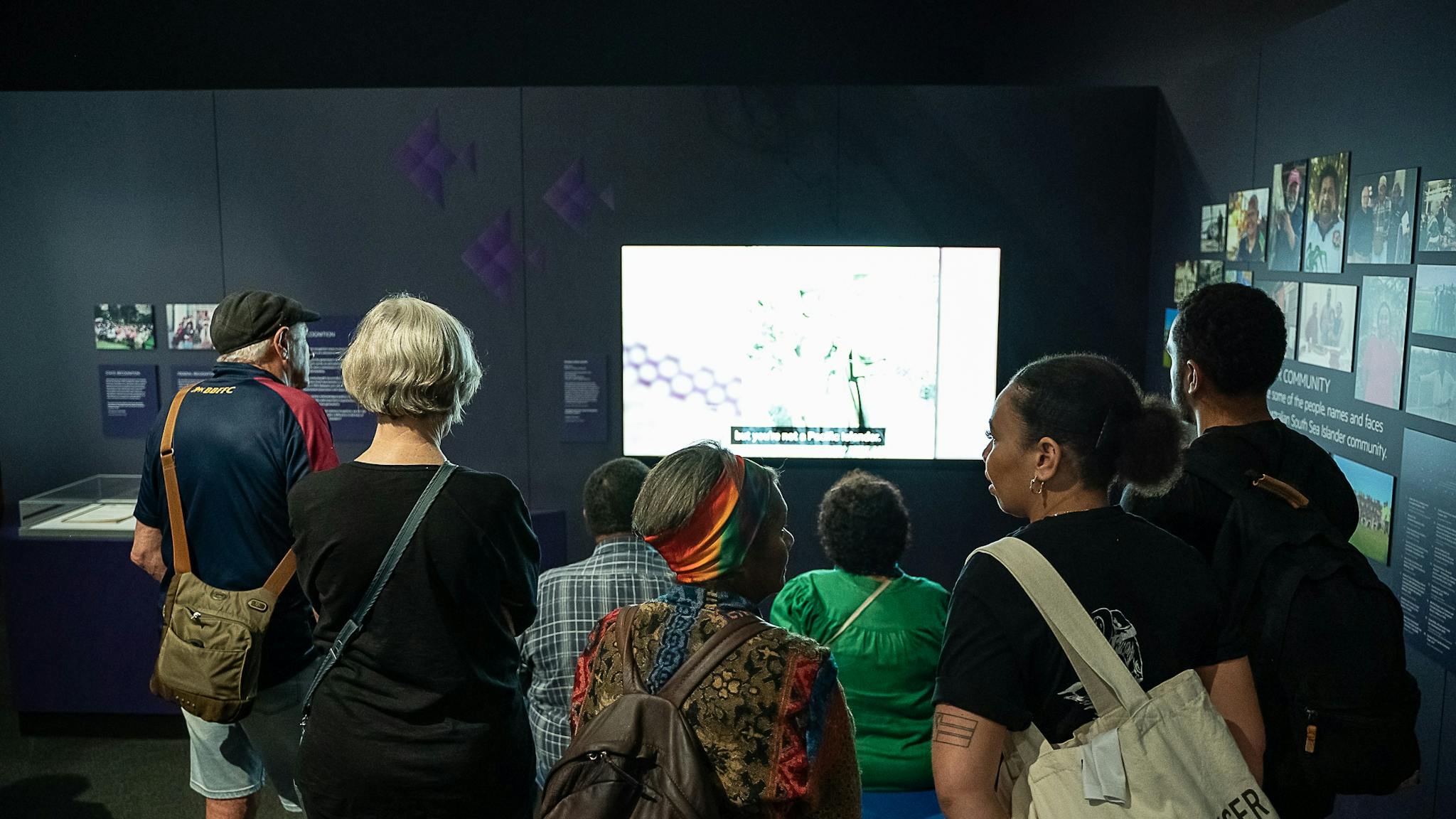 Exhibition visitors in front of a digital story