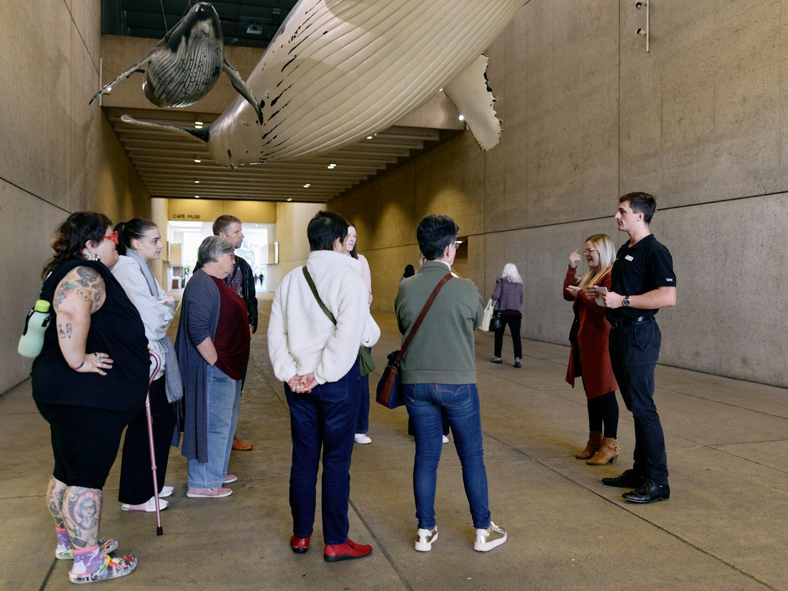 Visitors join a tour in the Whale Mall outside Queensland Museum Kurilpa