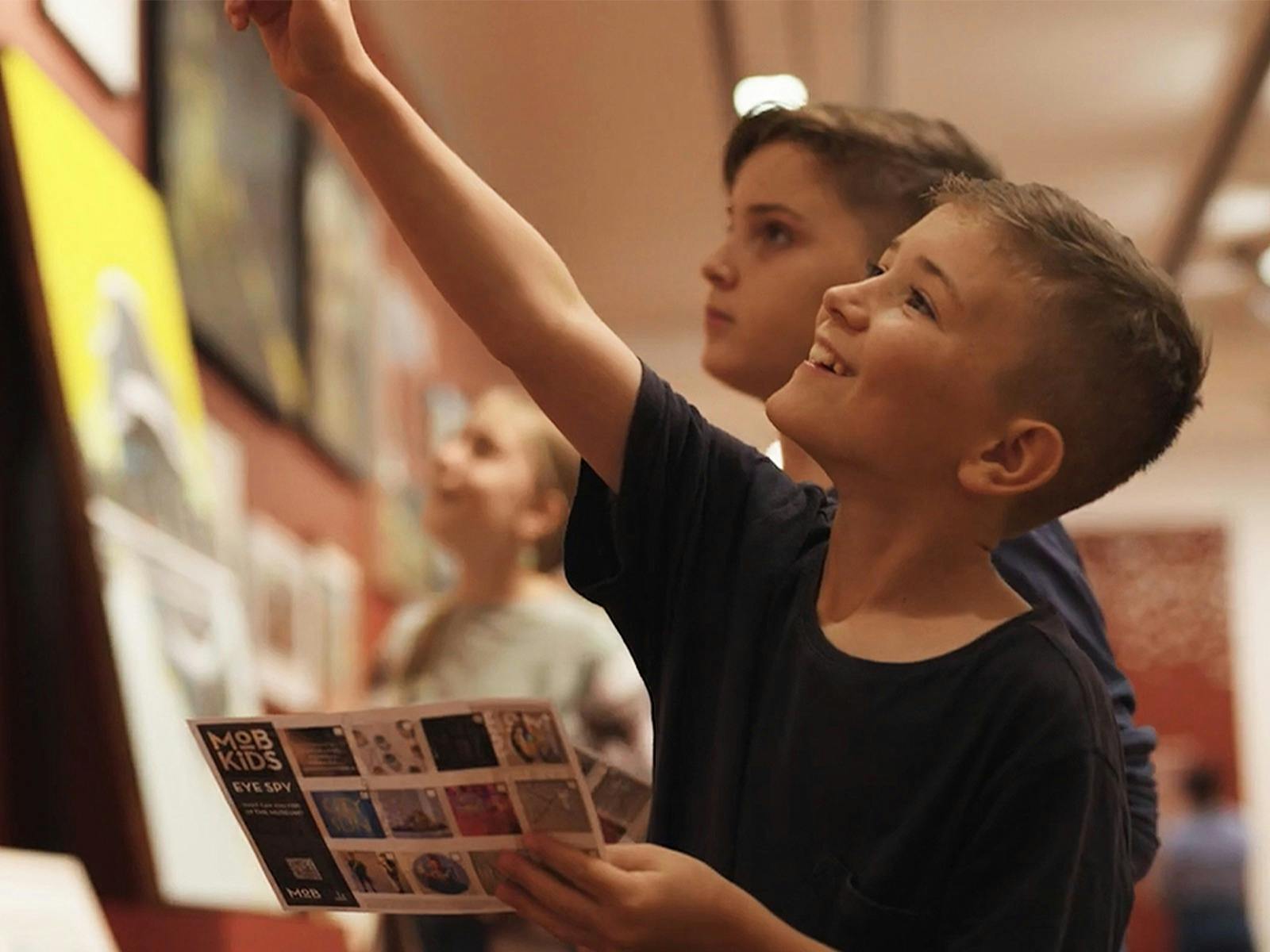 Child excited as he spots and points at something in the museum
