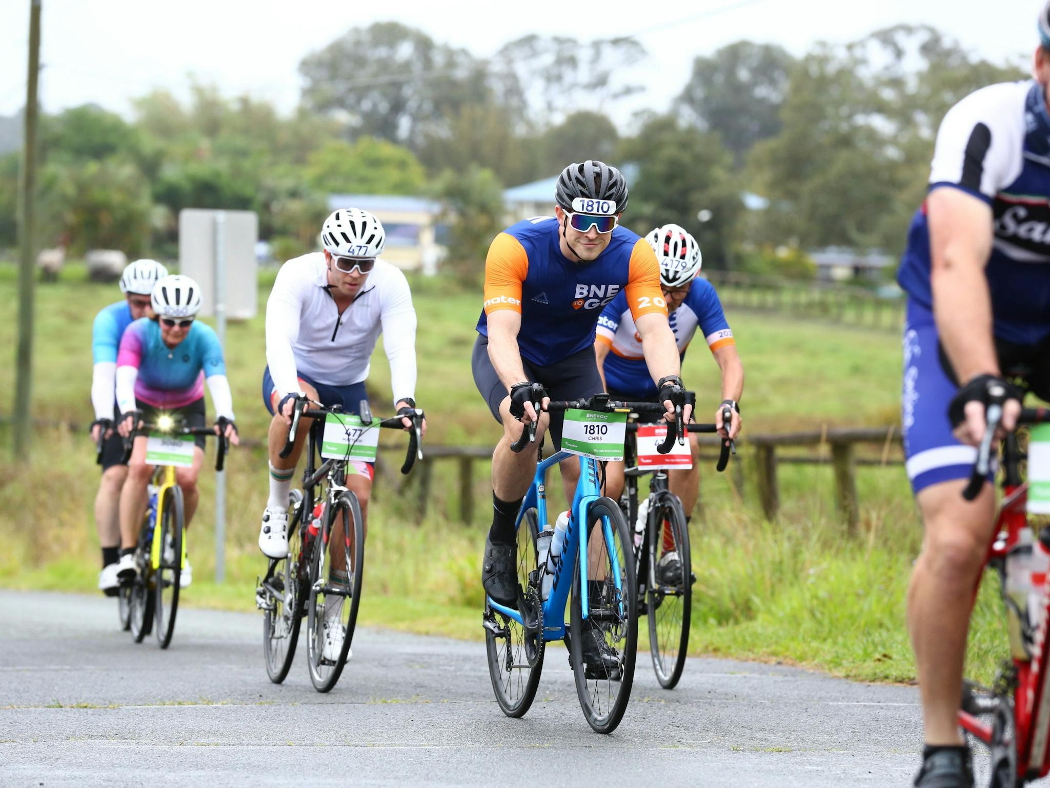 A group of cyclists riding on the road