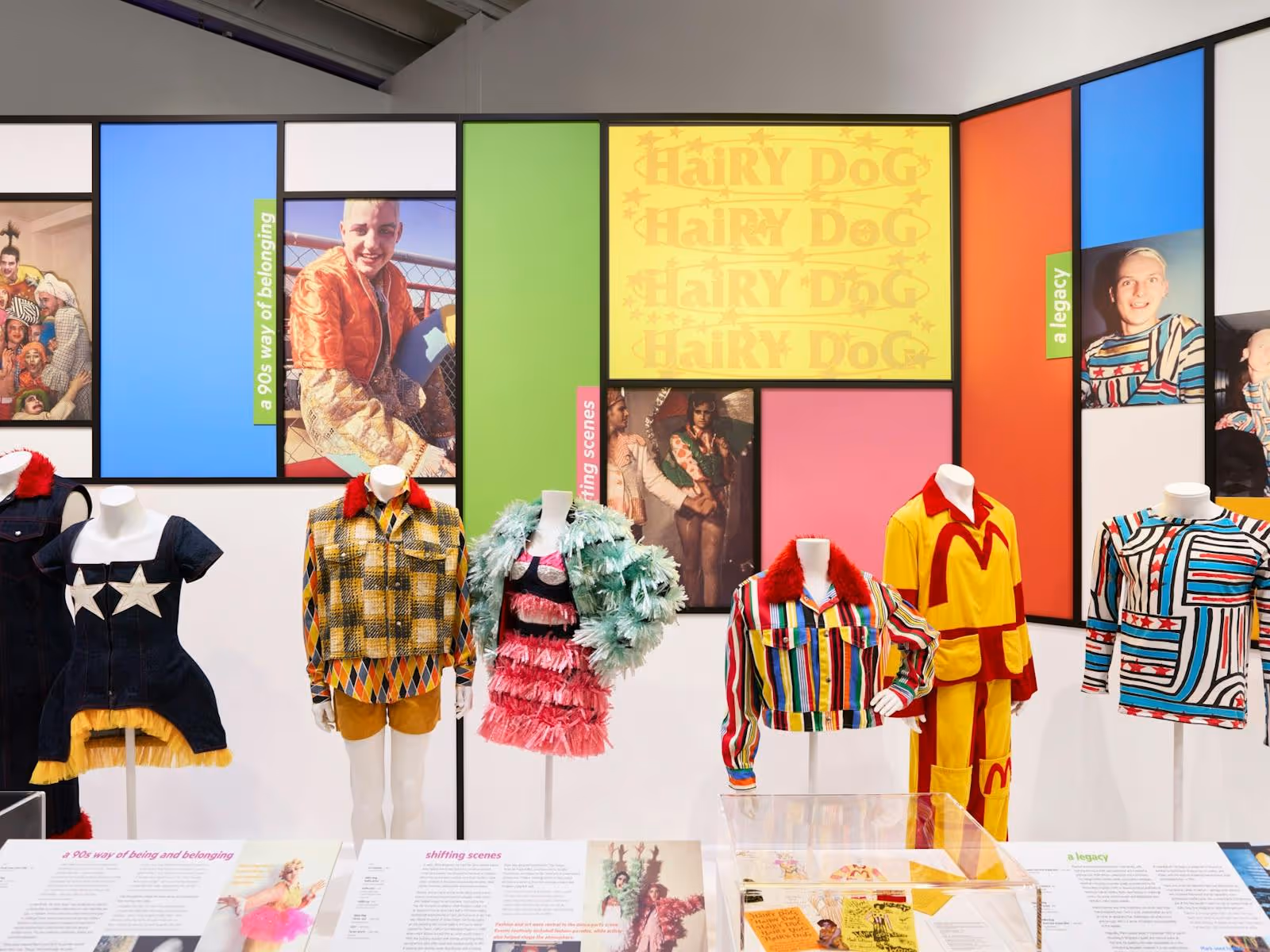 Bright, fashionable outfits from the 1990s displayed against a colourful backdrop.