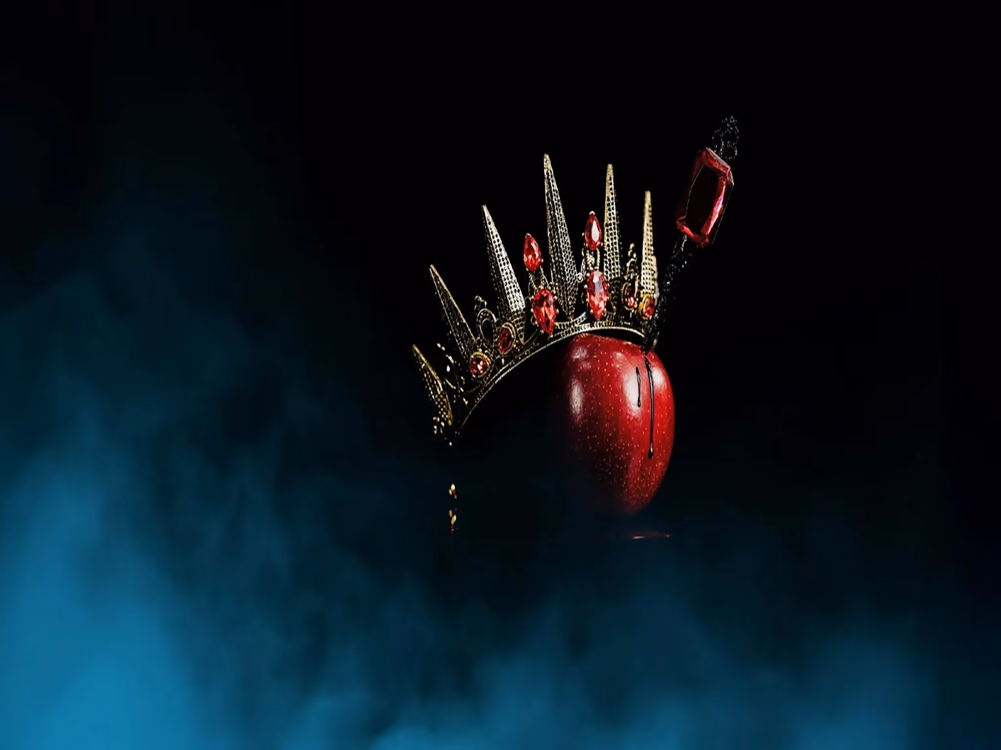 A red apple with a crown and dagger in it. Ballet Theatre Queensland Snow White.