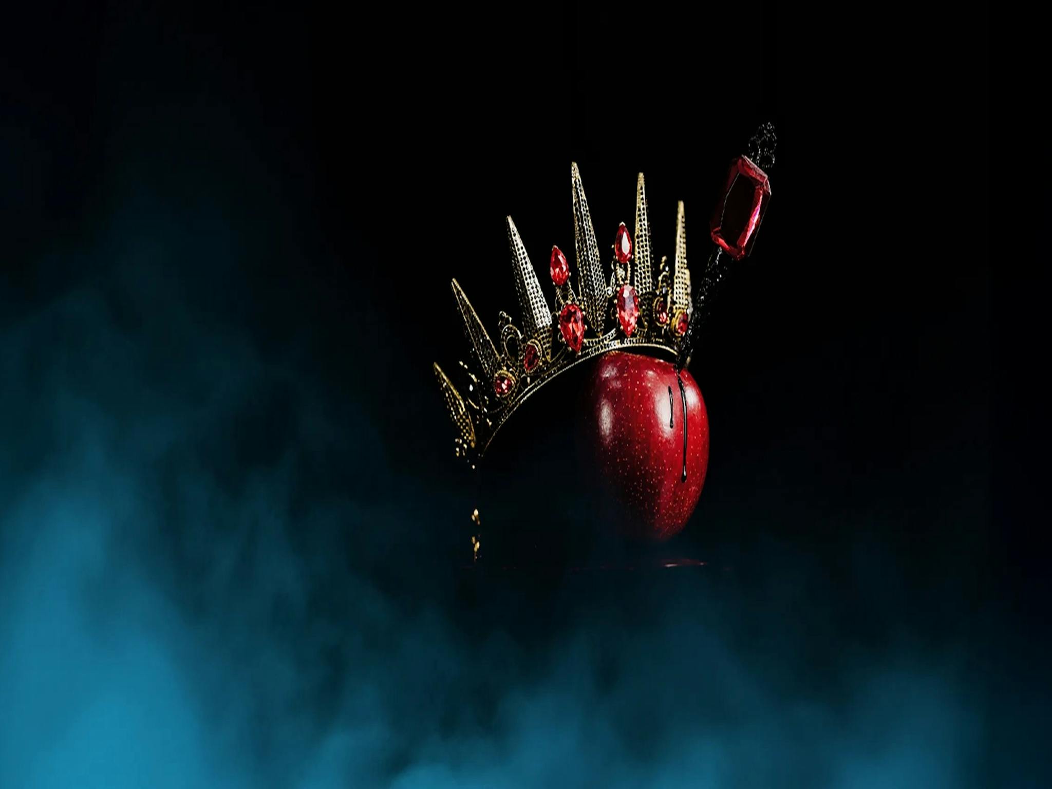 A red apple with a crown and dagger in it. Ballet Theatre Queensland Snow White.