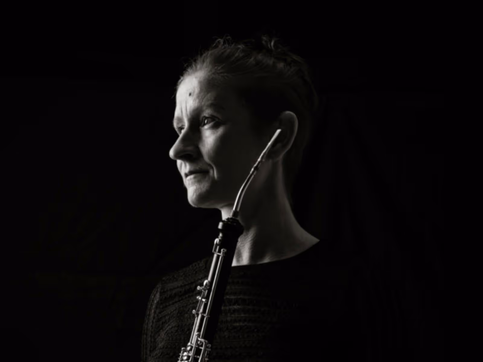Black-and-white portrait of a cor anglais in profile, looking toward the light