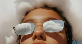 A creative portrait with clouds reflecting in sunglasses, illustrating the innovative potential of Nimbus Library.