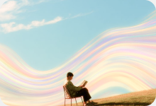 Person reading on a hill under colourful waves