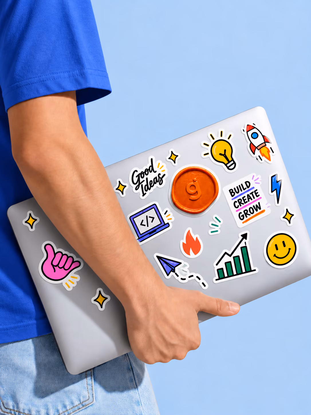 A Groie team member carrying a laptop covered in stickers