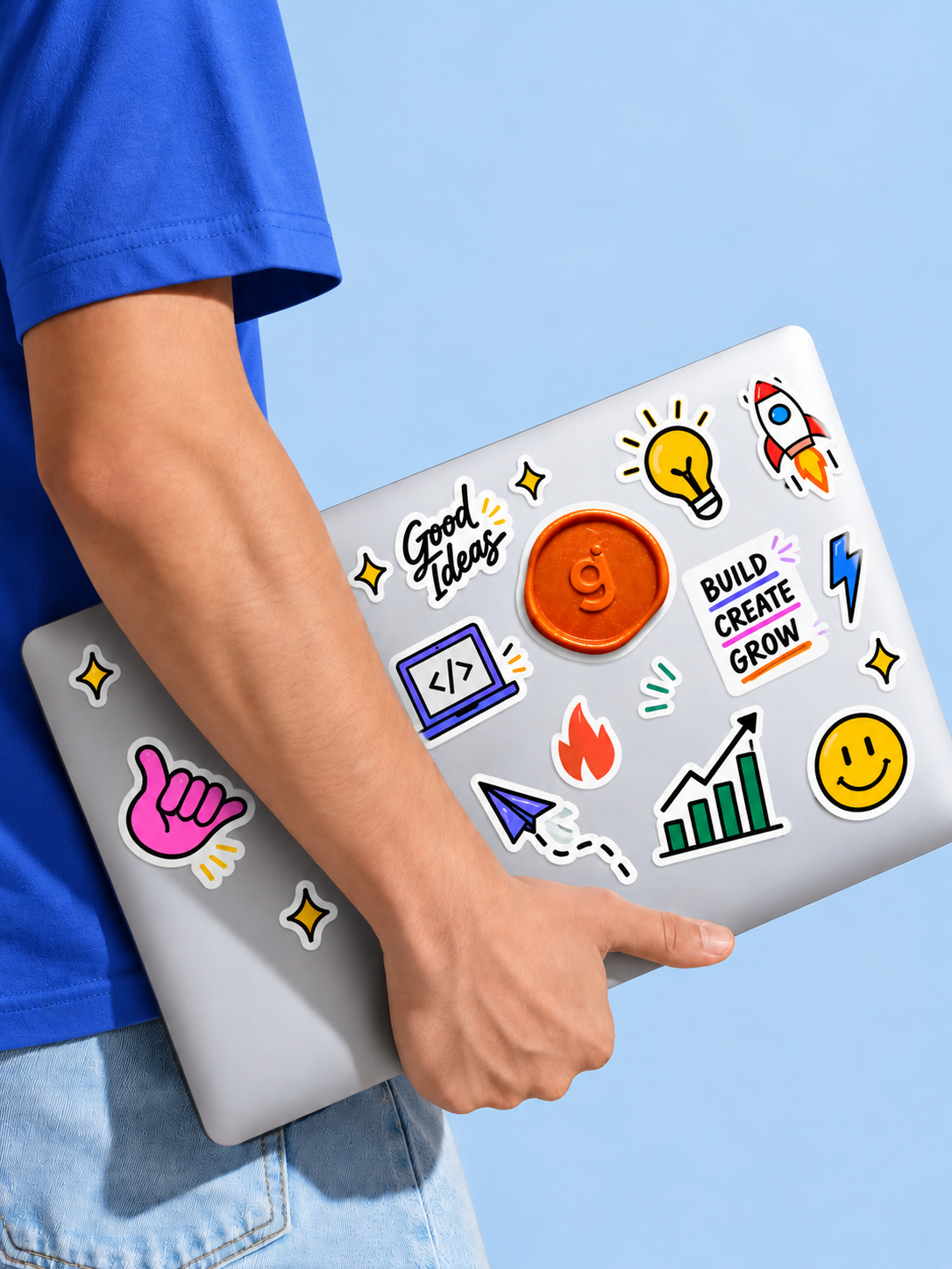 A Groie team member carrying a laptop covered in stickers