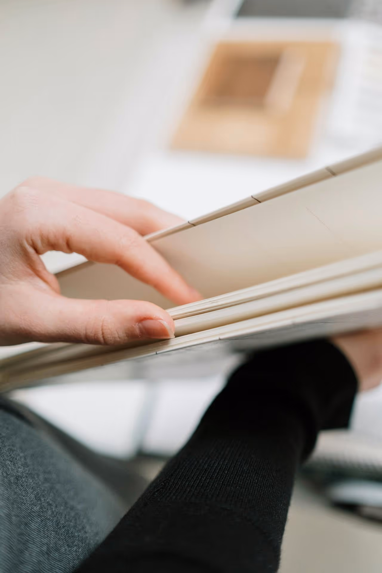 Close-up view of a hand turning pages in a notebook