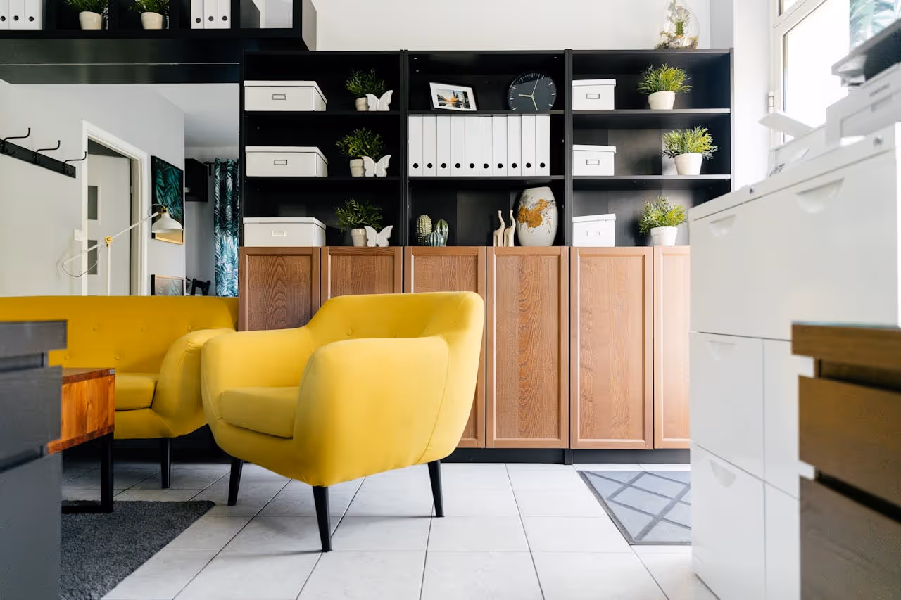 Office with yellow armchairs, shelves and folders