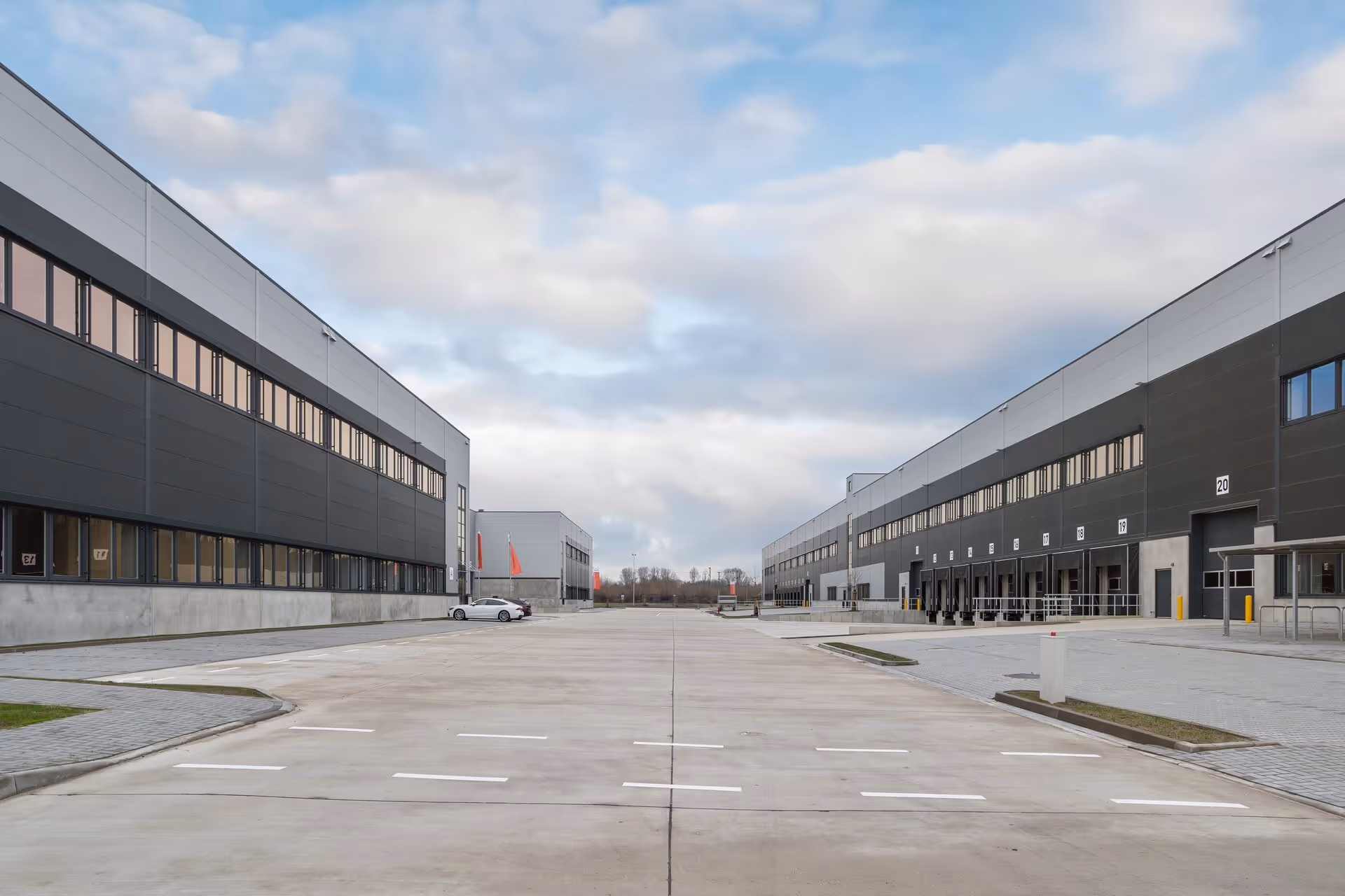 Front shot of the exterior of a warehouse with truck inlets