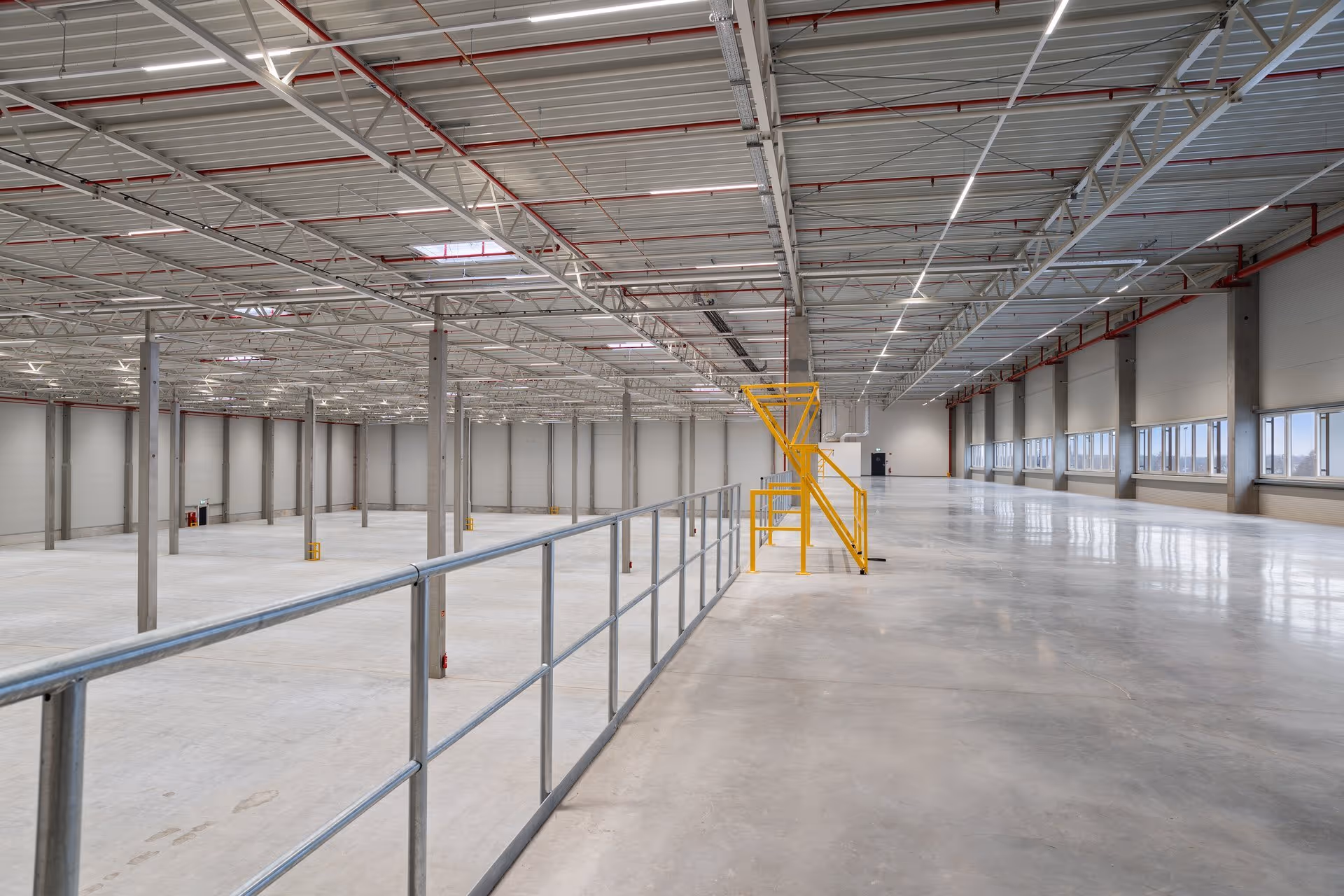 Angled interior of an empty warehouse with artificial light