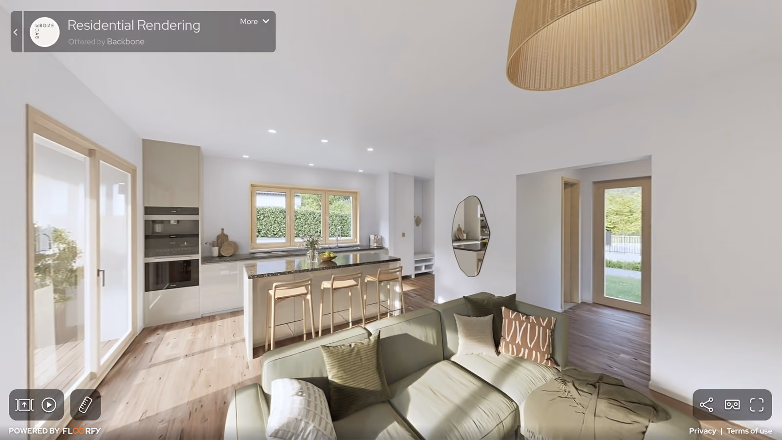 Modern residential open kitchen and living room with green sofa, wooden stools, and large windows.