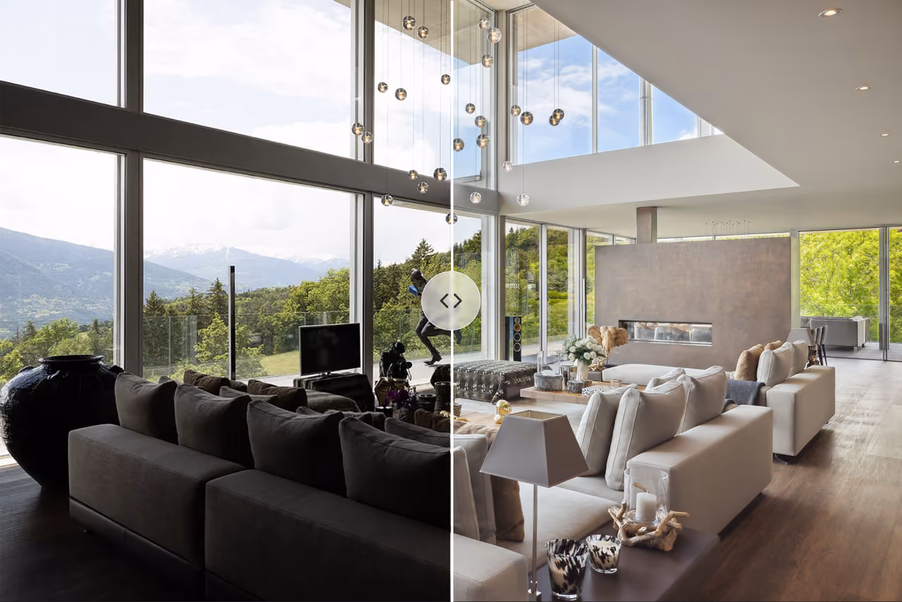 Modern living room with large windows showing a mountain view, split by dark and bright lighting.