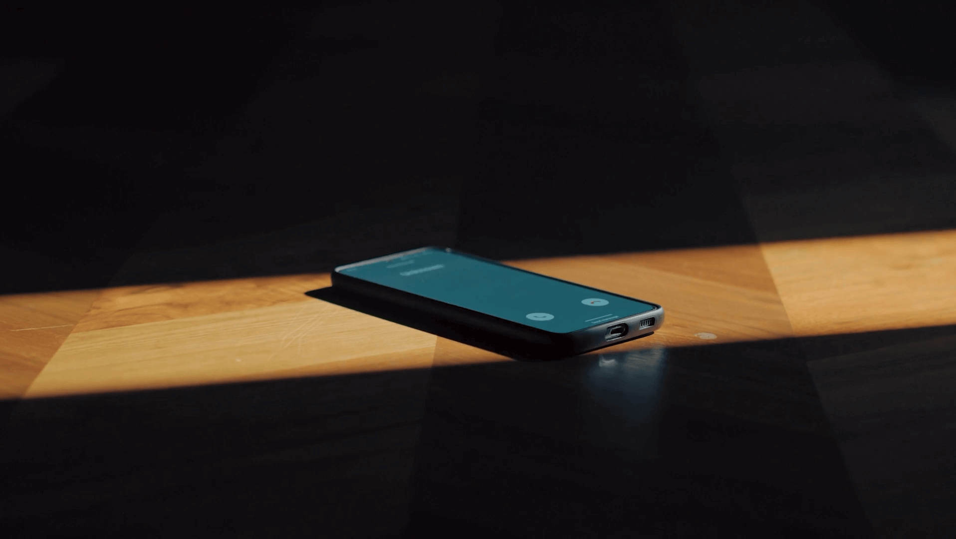 Smartphone left unattended on a desk during an incoming call, illustrating how vishing attacks use real-time voice impersonation to bypass enterprise controls and manipulate users through urgency and trust.