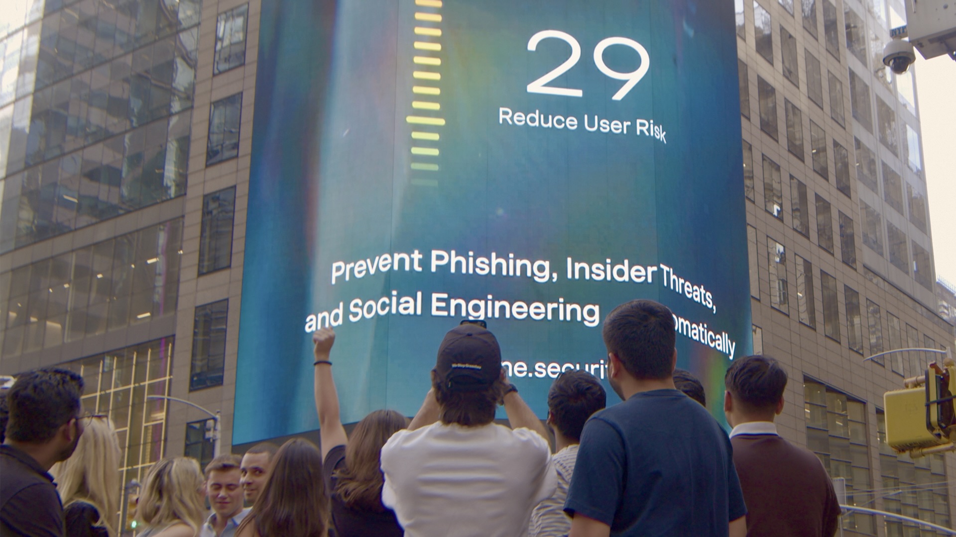 The Dune Security team standing in front of a six-story Times Square billboard showcasing the company’s mission to prevent insider threats, reduce user risk, and protect enterprises from social engineering attacks and AI risks. 
