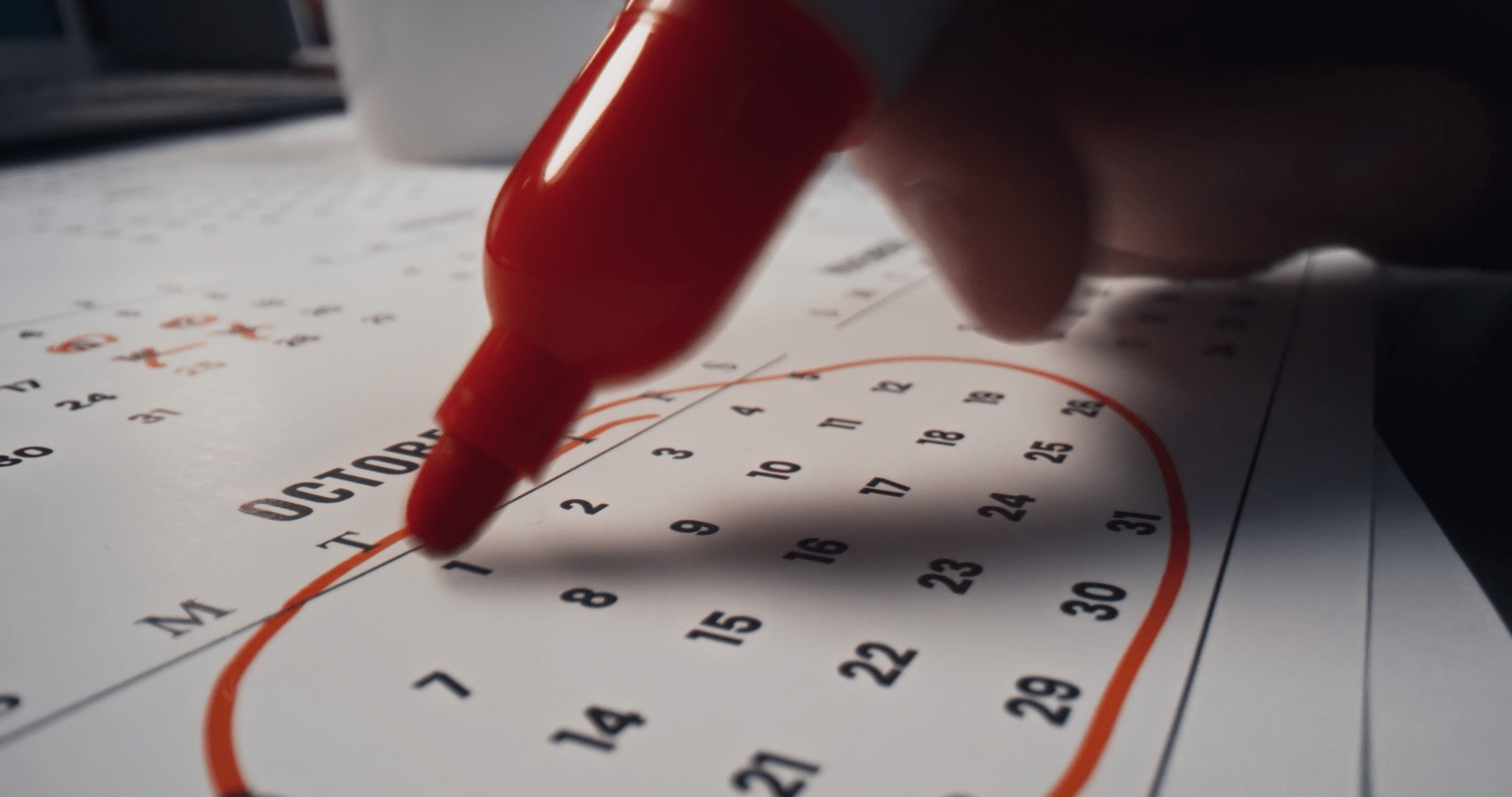 October calendar with dates circled in red marker, representing Cybersecurity Awareness Month planning and increased employee engagement.