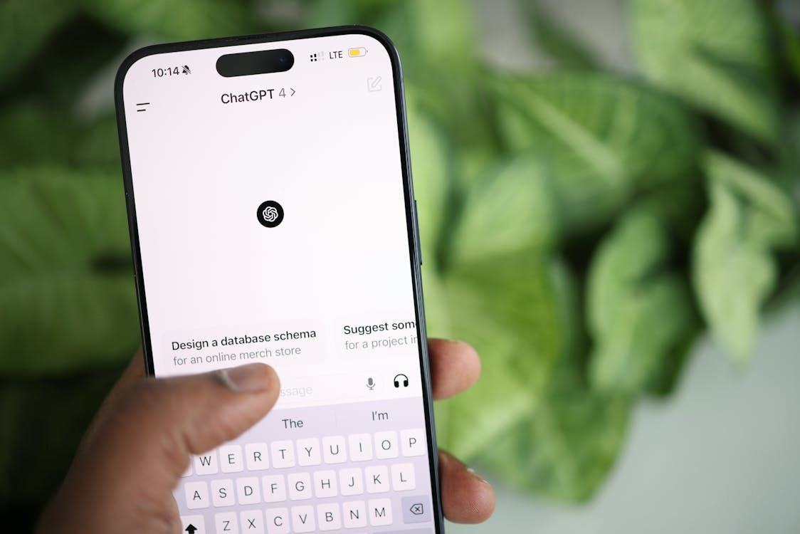 Hand using the ChatGPT mobile app with prompt suggestions, the generative AI behind scaled social engineering attacks