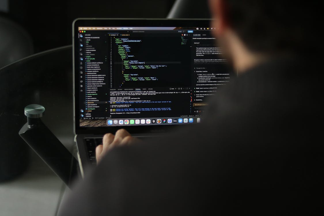 A developer working in a code editor and terminal, representing the privileged system access behind insider threats