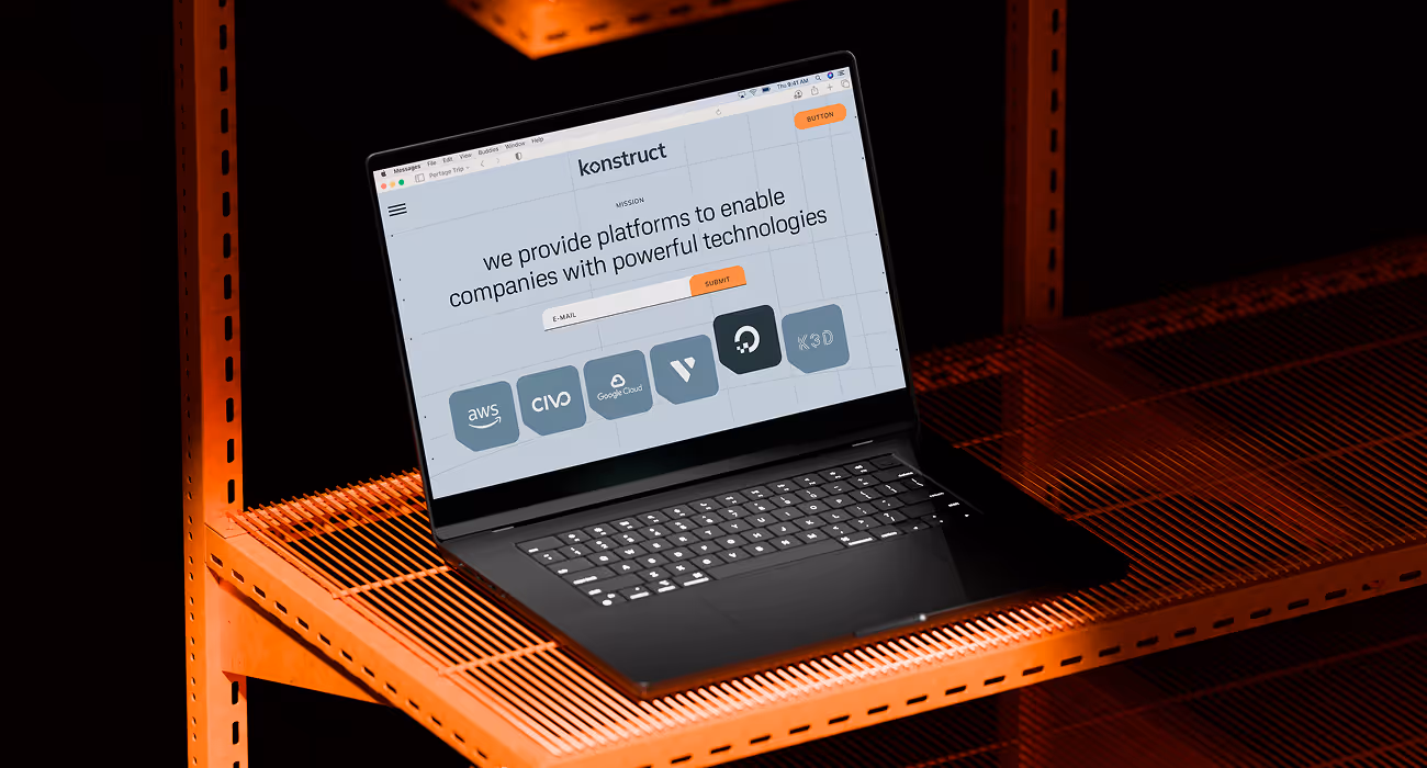 Konstruct website design on a laptop — SaaS internal developer platform displayed on industrial orange server rack shelving