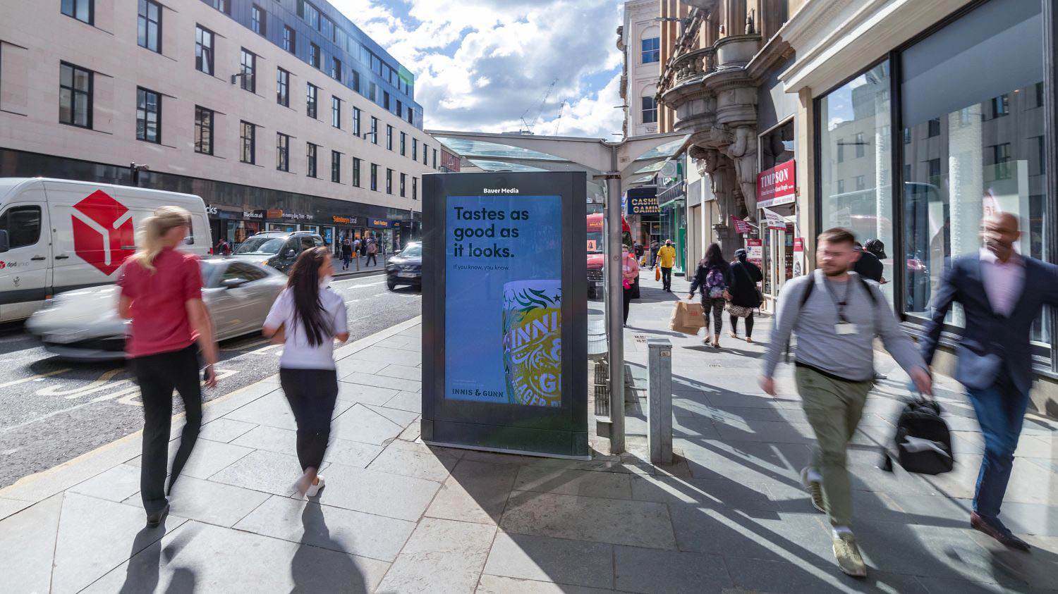 Digital screen on a bus stop showing ad for Innis & Gunn