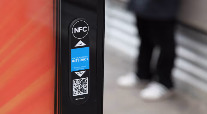 Mobile tag on a bus shelter, including a QR code and NFC