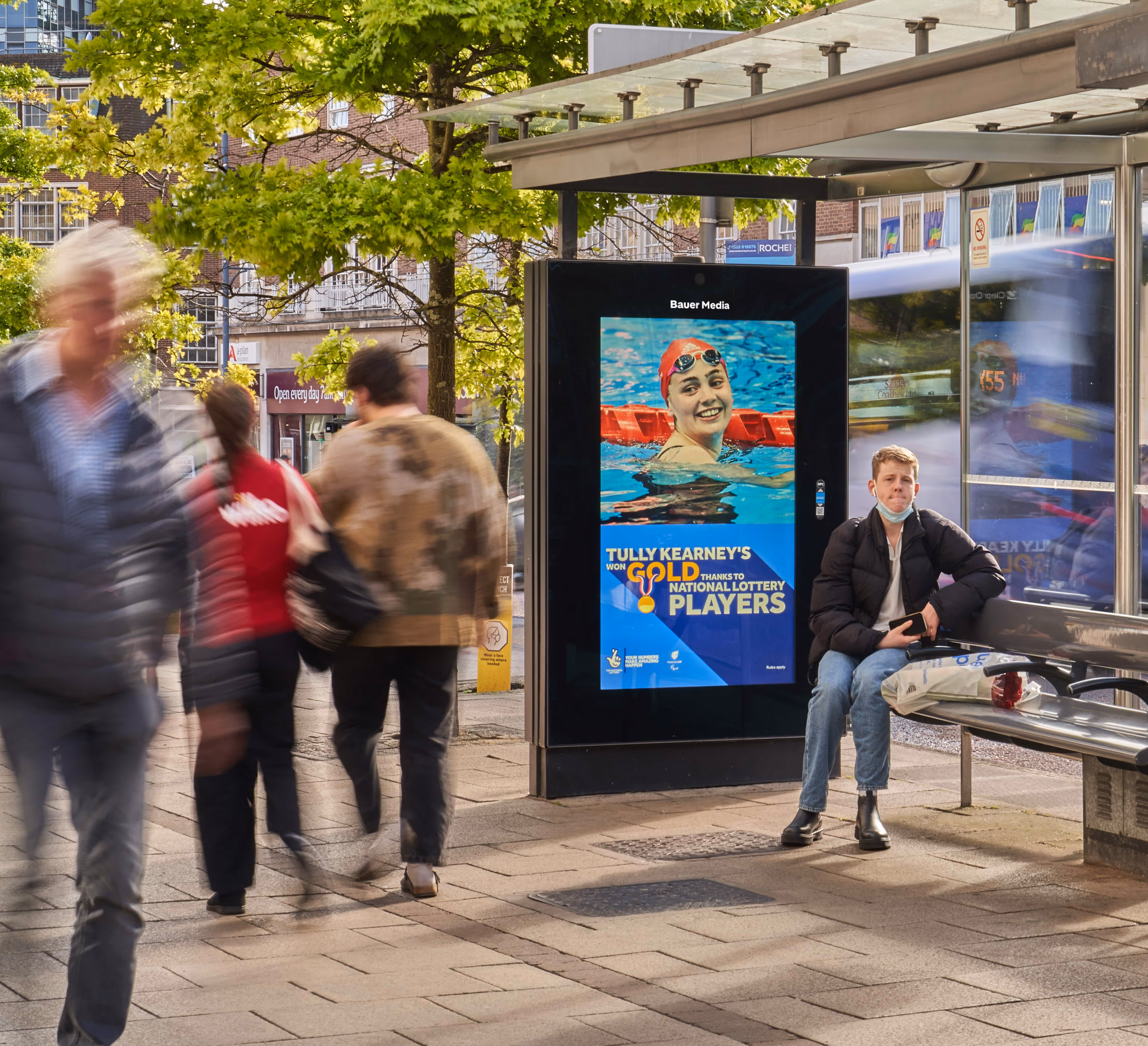 A National Lottery Adshel Live campaign at a bus stop