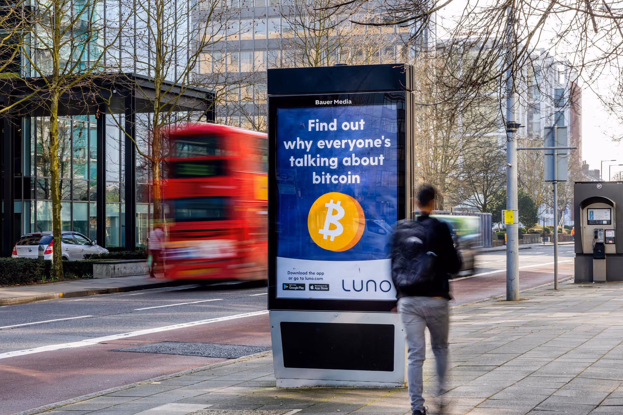 Adshel Live poster campaign featuring a Luno ad with a red bus in the background