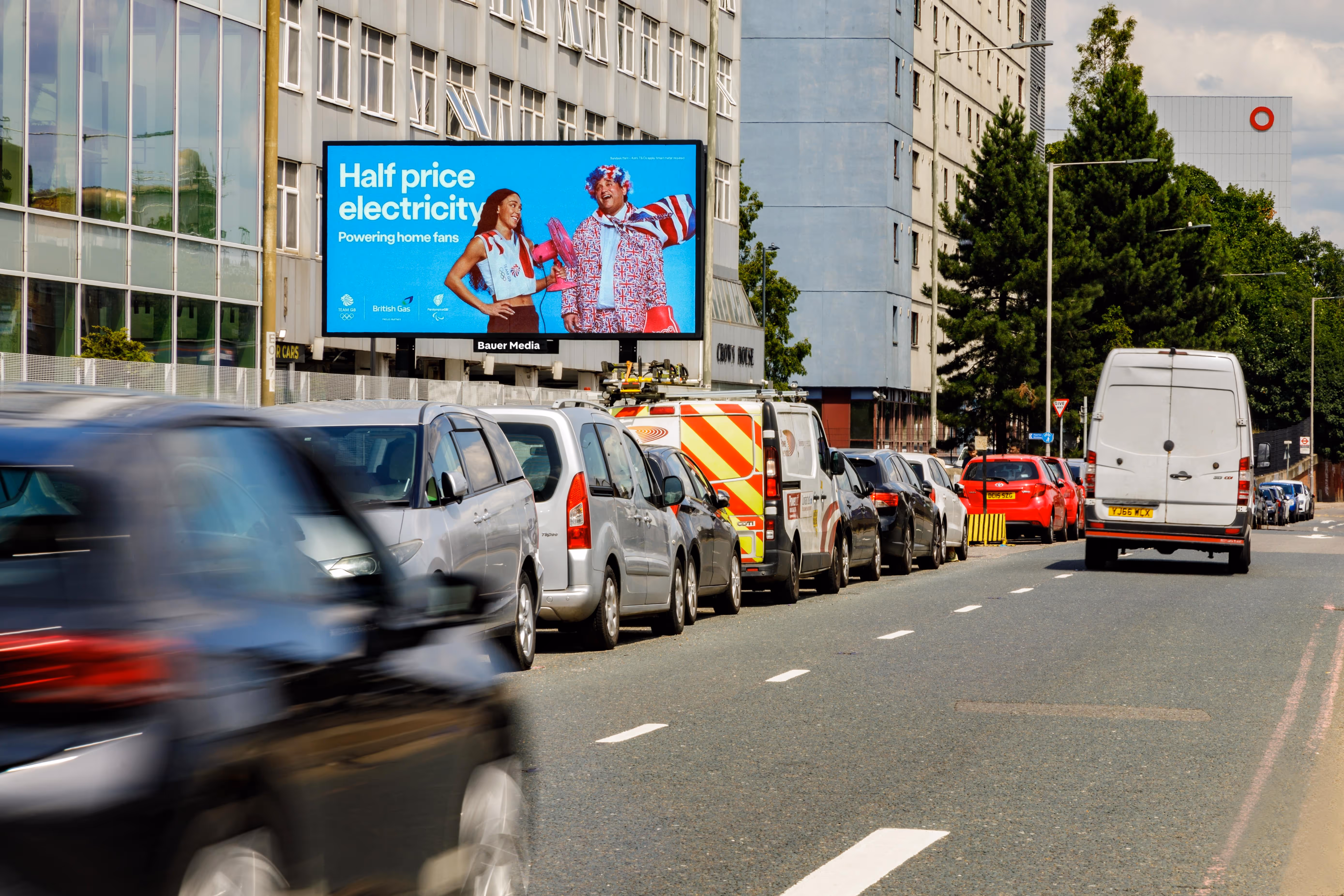 An electricity campaign on a digital billboard in London with traffic at a standstill