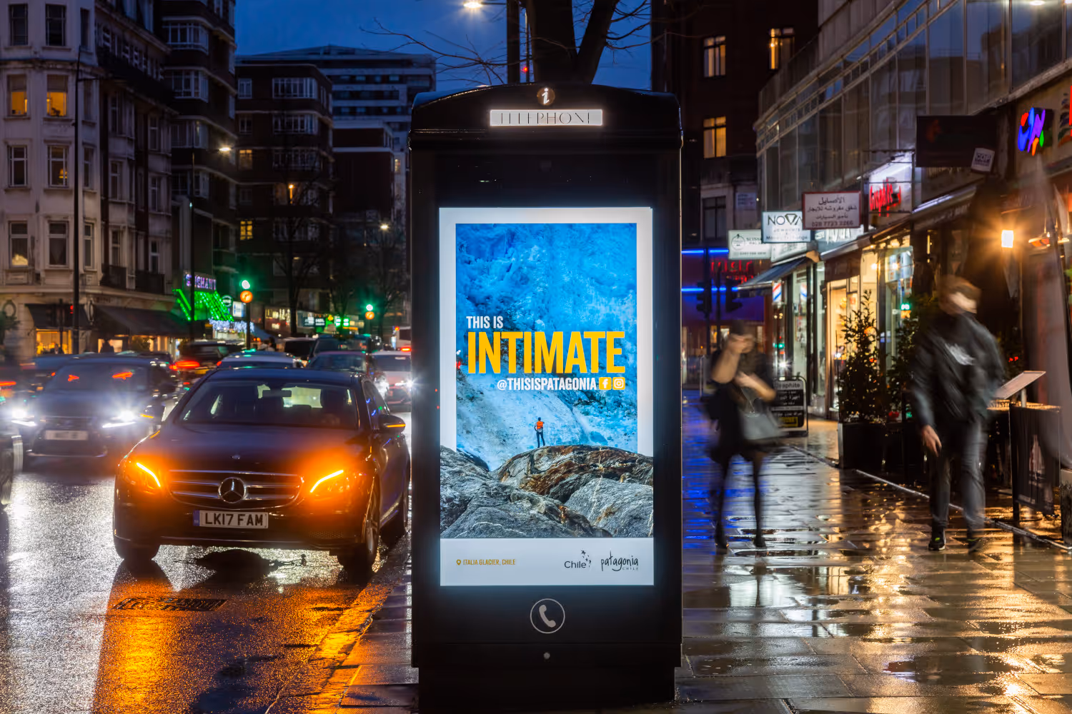 Chile Tourism advertising on a roadside digital payphone screen at night in London