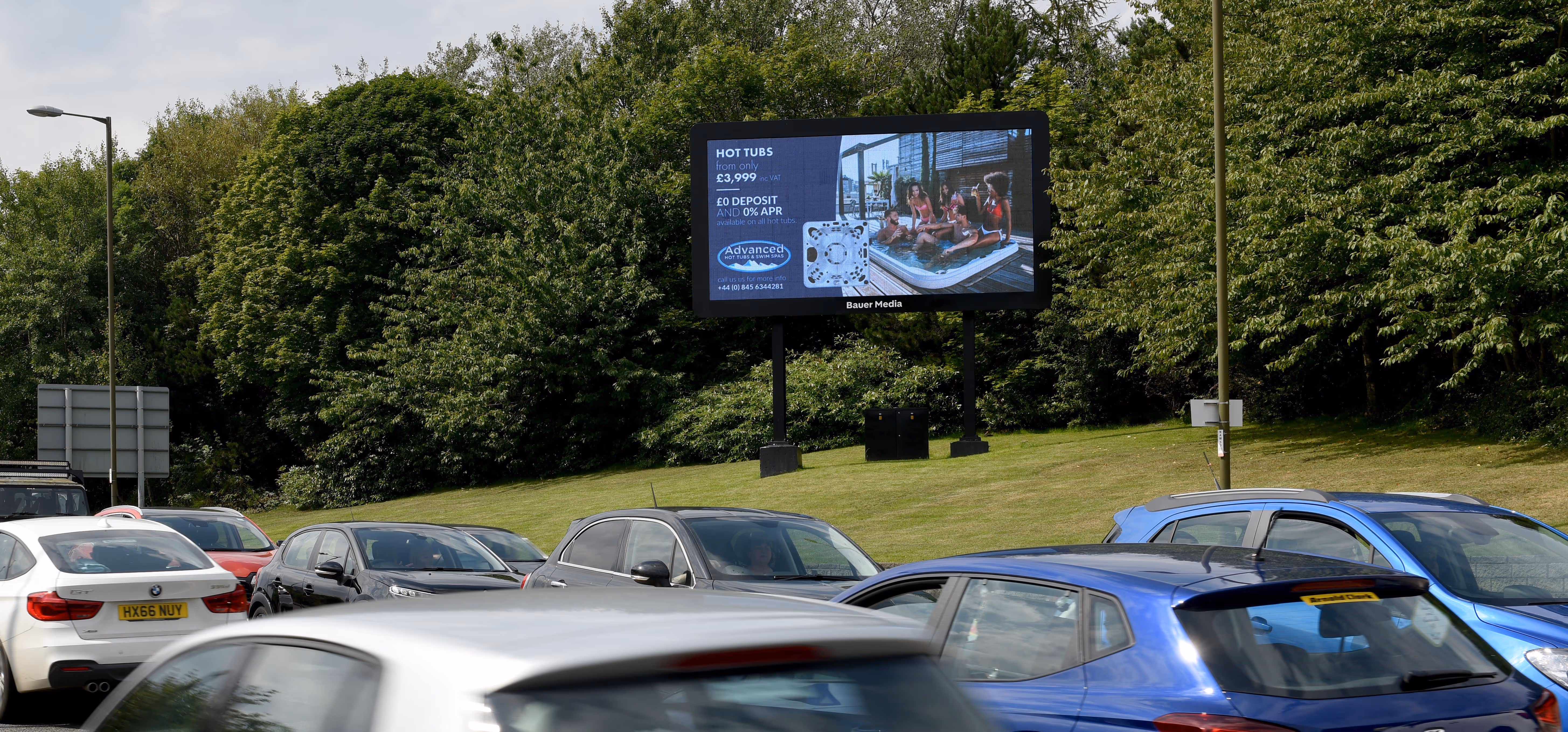 A hot tub ad campaign displaying a roadside digital billboard