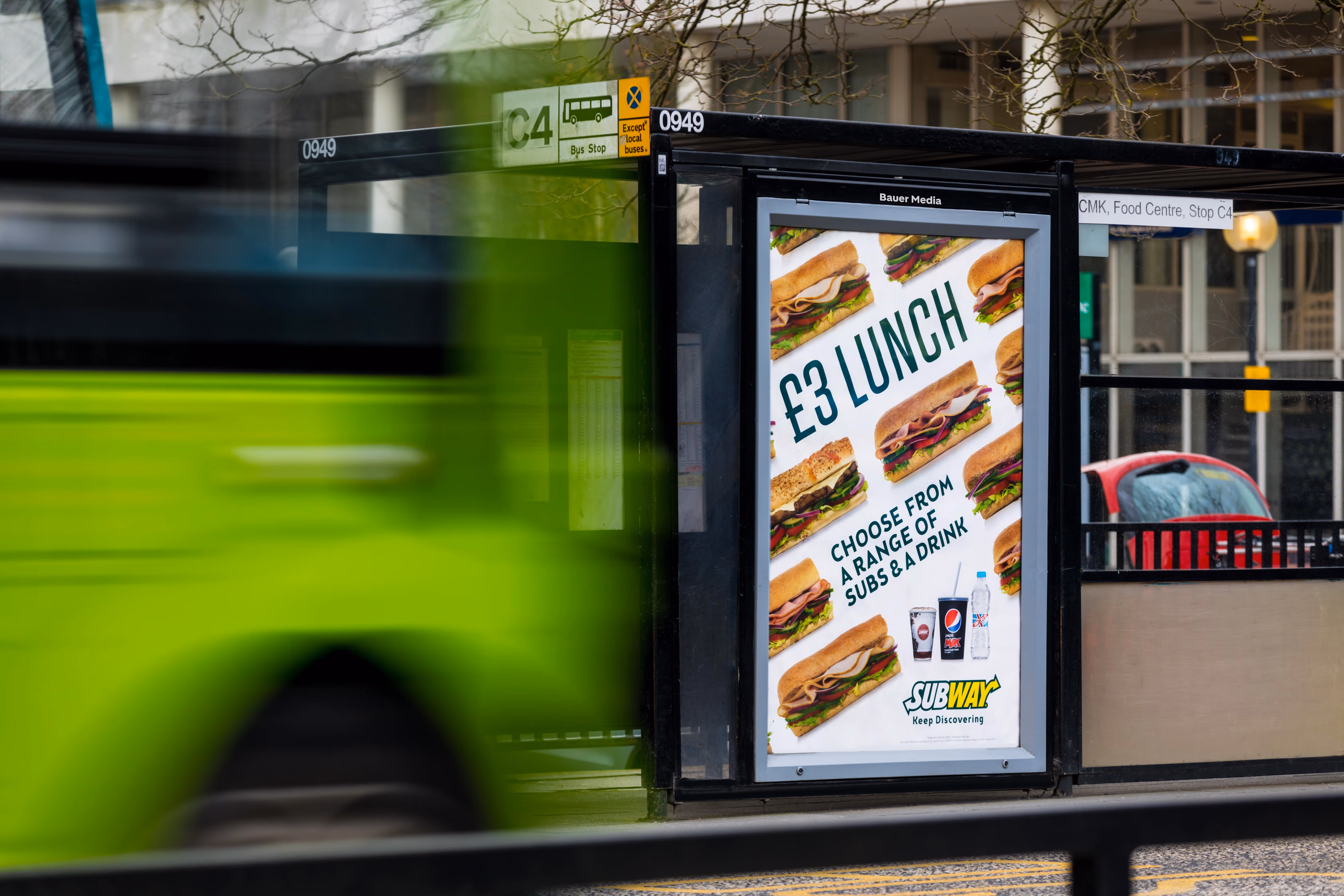 Subway ad campaign on a bus stop poster