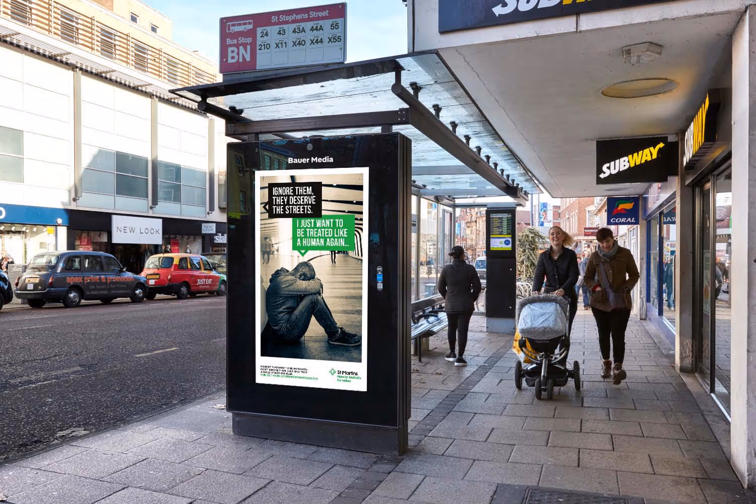 St Martins Bus Shelter ad as people walk past