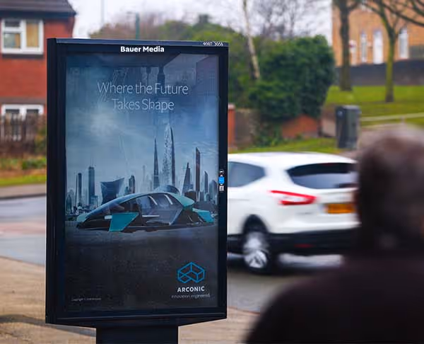 Arconic's ad as a car and person walk past