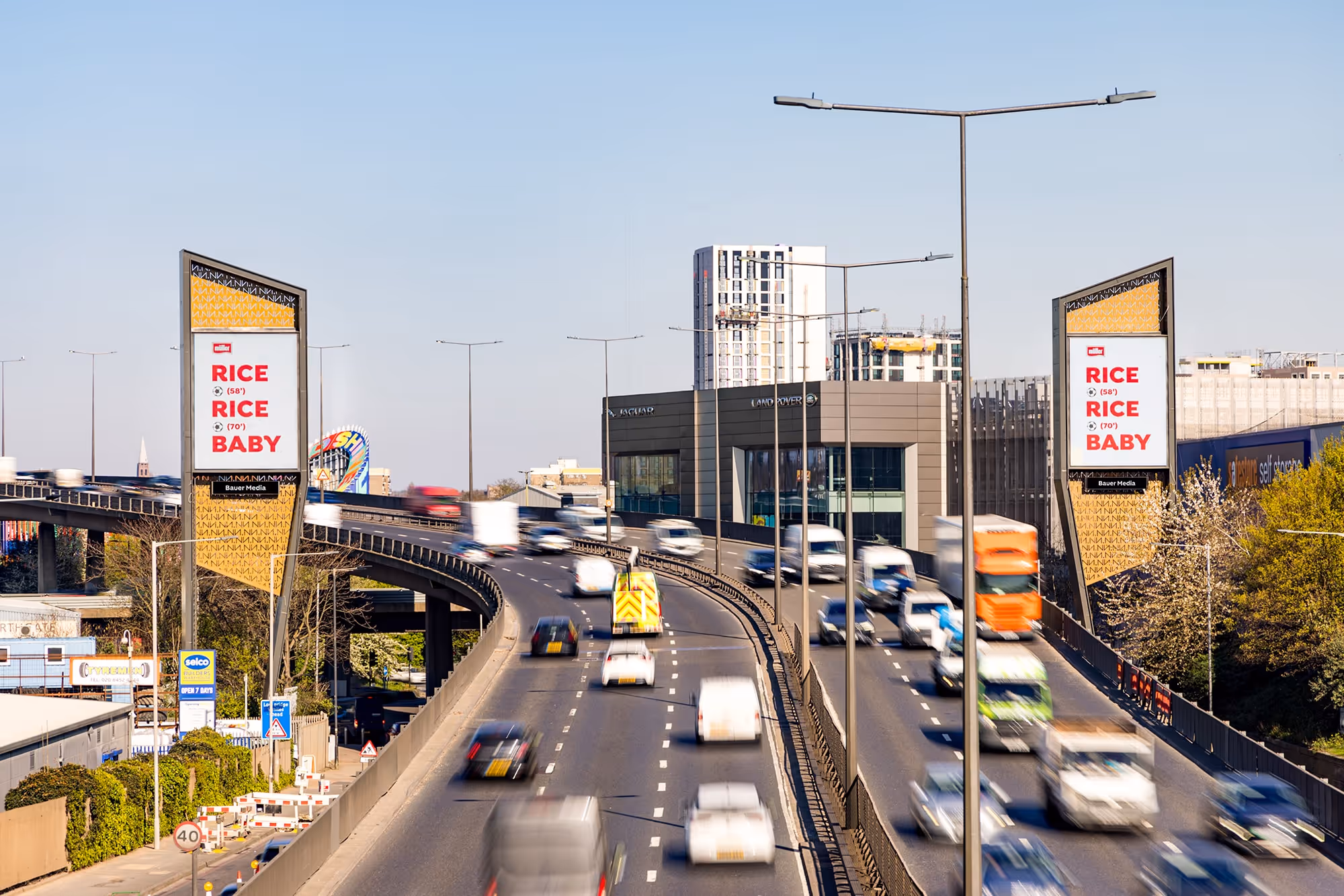 Muller advertising on two huge digital billboards alongside a motorway in London