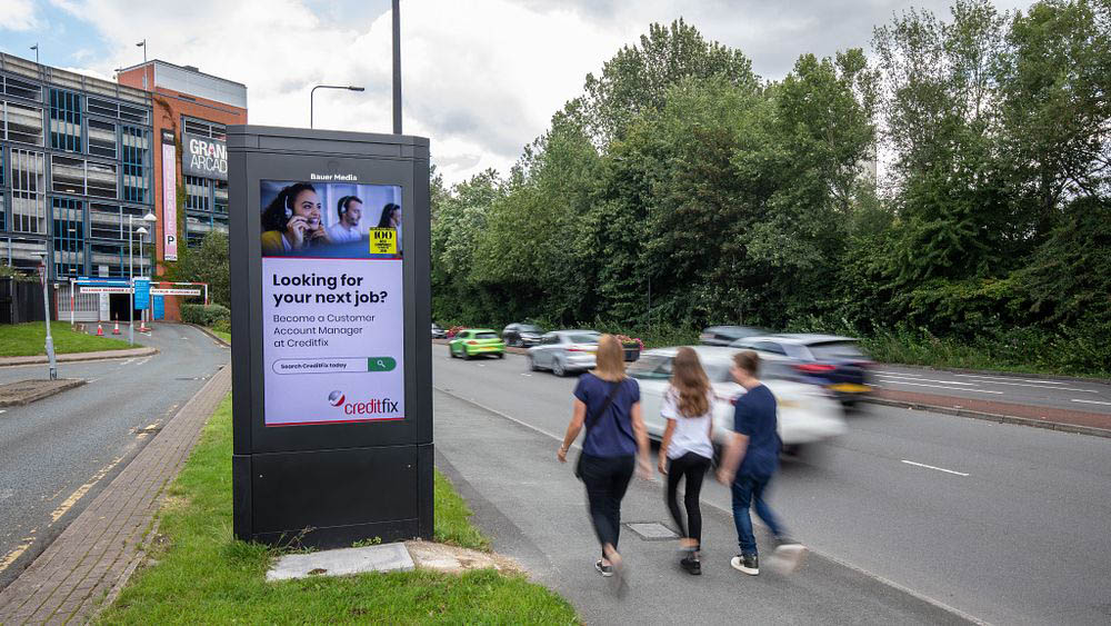 Creditfix's successful digital roadside ad campaign with people walking past